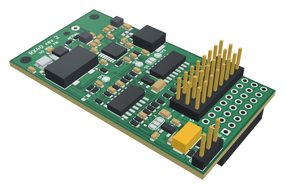The RX40 receiver board seen from an angle: the radio parts at the aerial end, the comparator and decoder chips in the middle, and a block of servo pins at the other end.